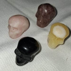 Set of Four Stone Skull Figurines